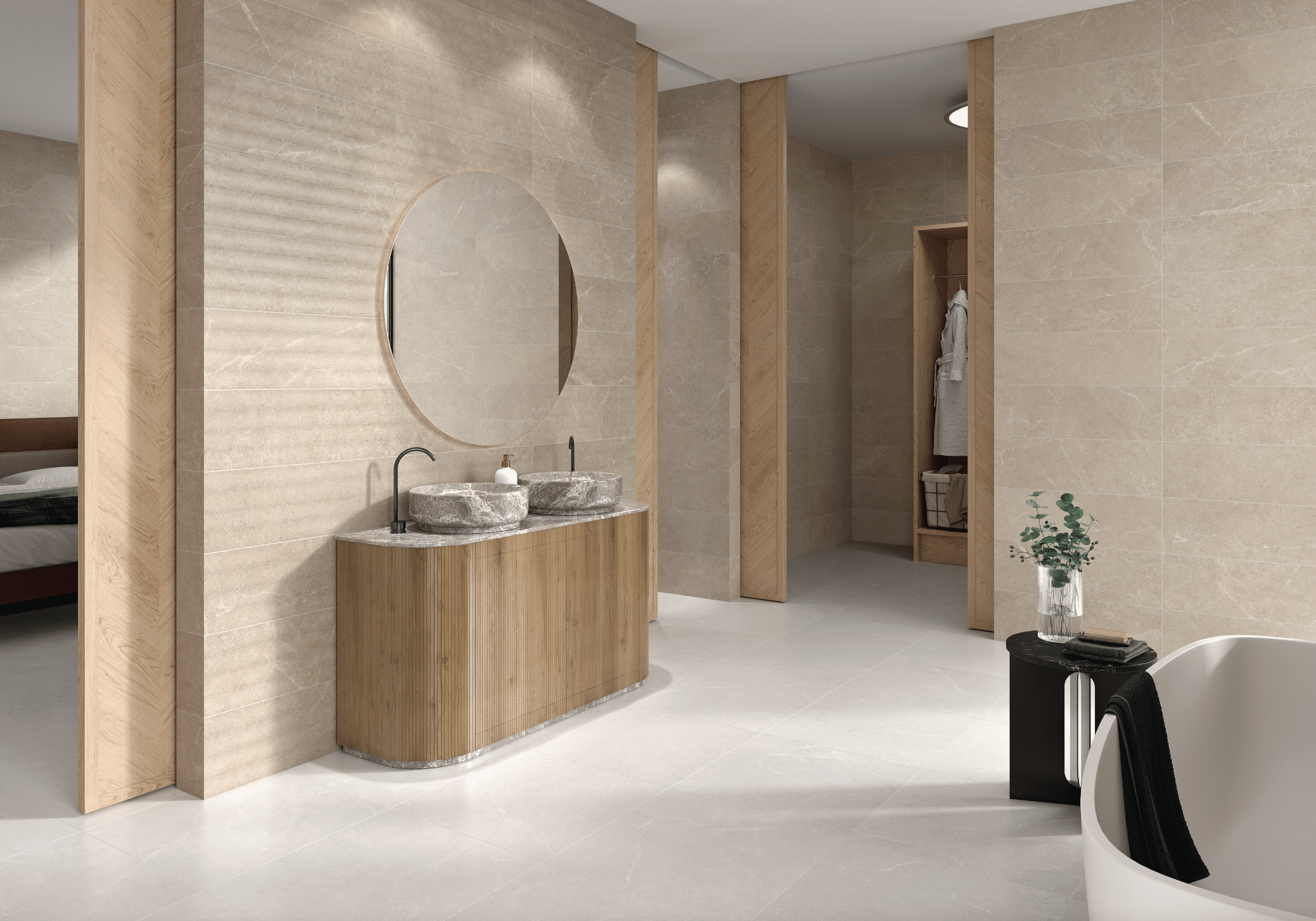 C. Bergmann zeigt ein offenes, gefliestes Badezimmer in Naturtönen mit einem Doppelwaschtisch, grauen Waschbecken und einer freistehenden Badewanne von Argenta.