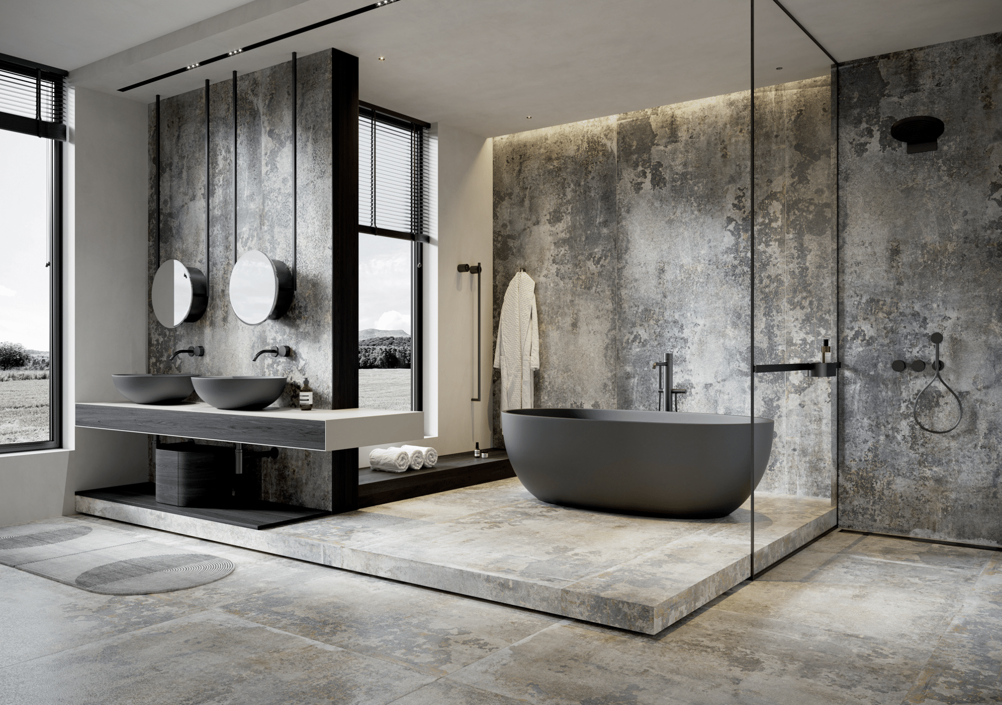 C. Bergmann zeigt ein Badezimmer mit XXL-Fliesen in dunklegrau-weiß, Doppelwaschtisch, freistehender Badewanne und Glastrennung von Cerrad.