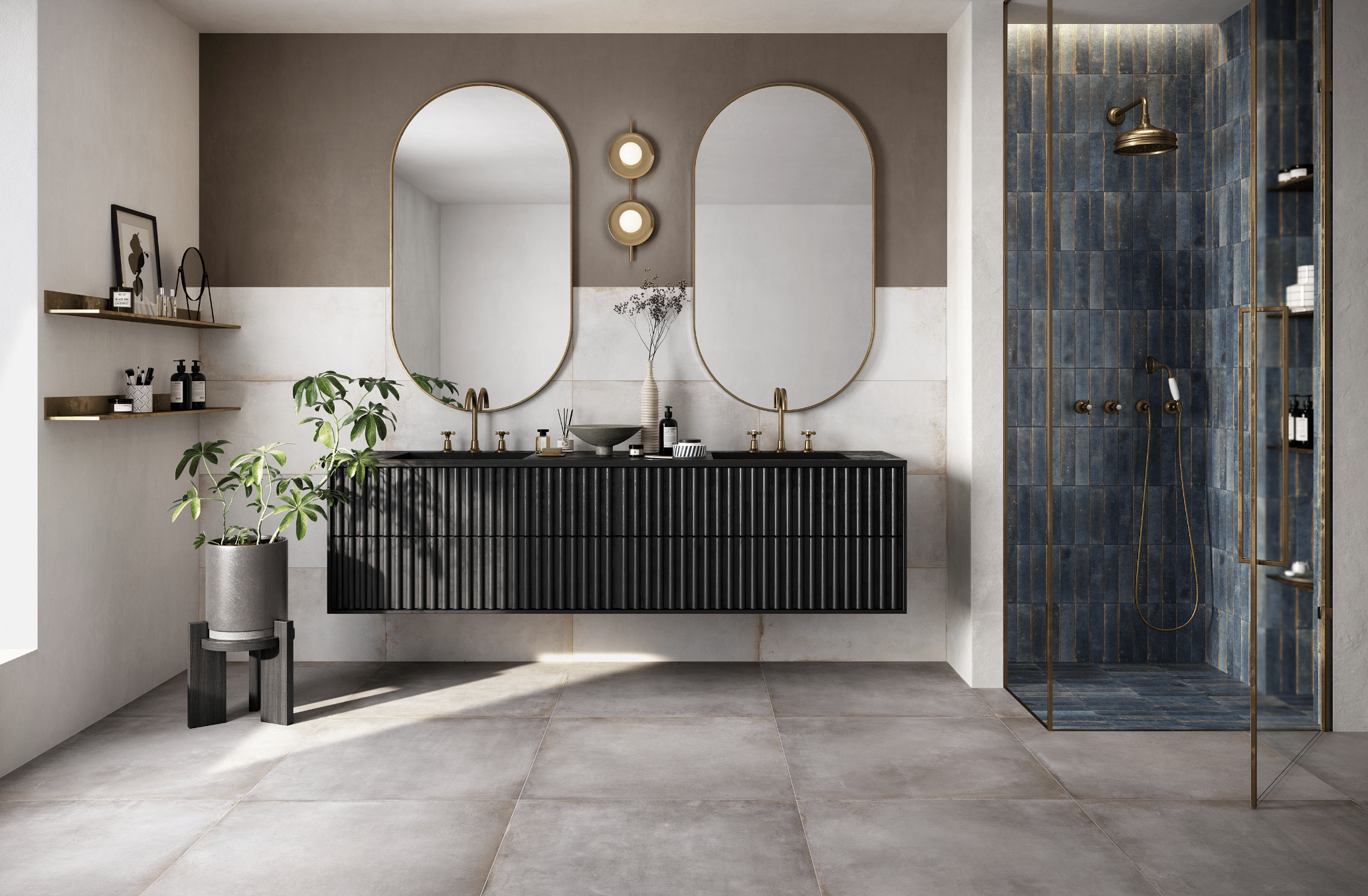 Fliesendorf zeigt ein Badezimmer mit sehr elegantem Doppelwaschbecken, zwei ovalen Spiegeln, graue, quadratische Fliesen am Boden und einer Dusche mit blauen Fliesen.
