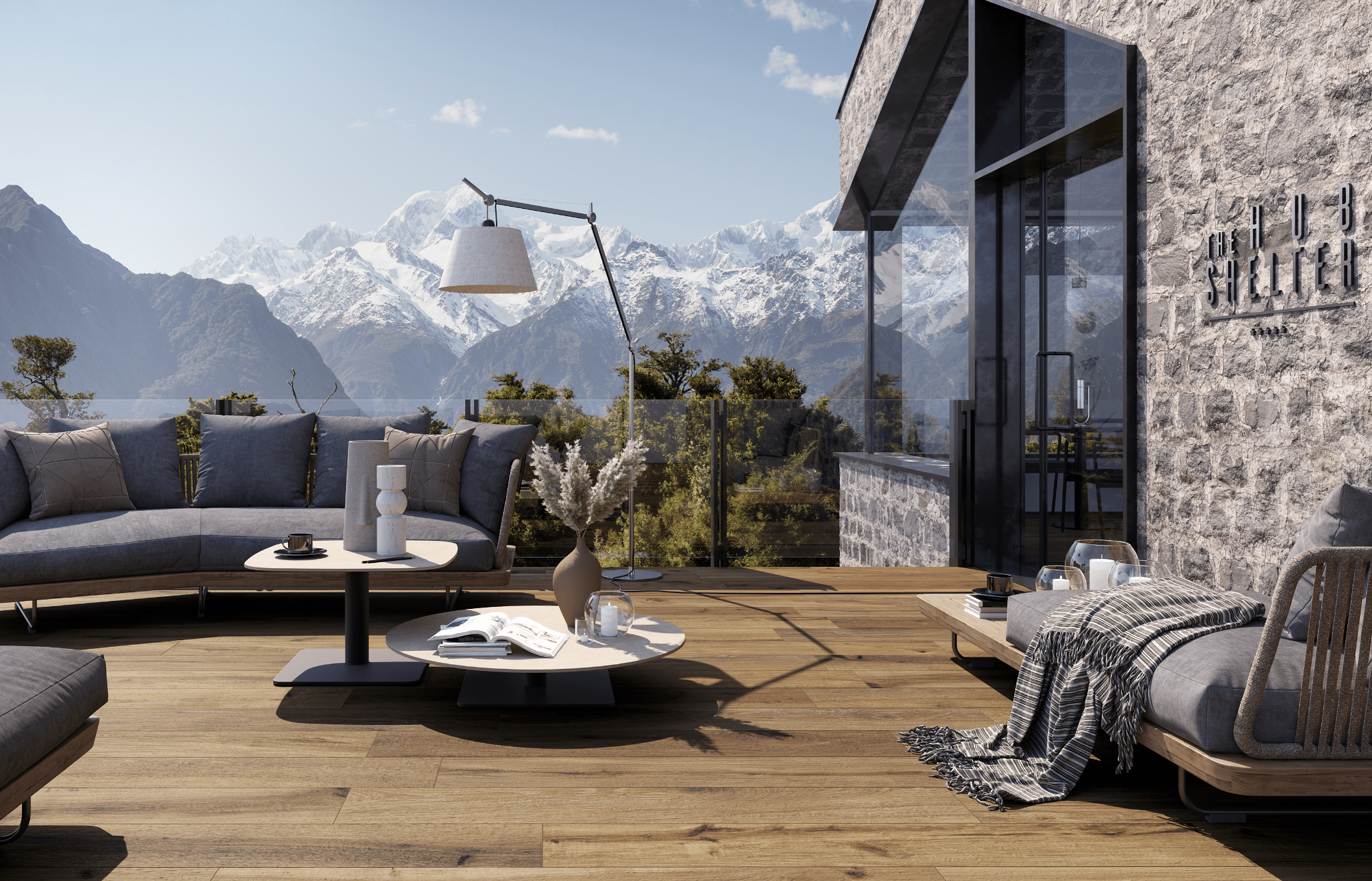 Fliesendorf präsentiert eine großzügige Terrasse mit Fliesendielen in Holzoptik, einer gemütlichen Lounge und Tischchen direkt in den Bergen.
