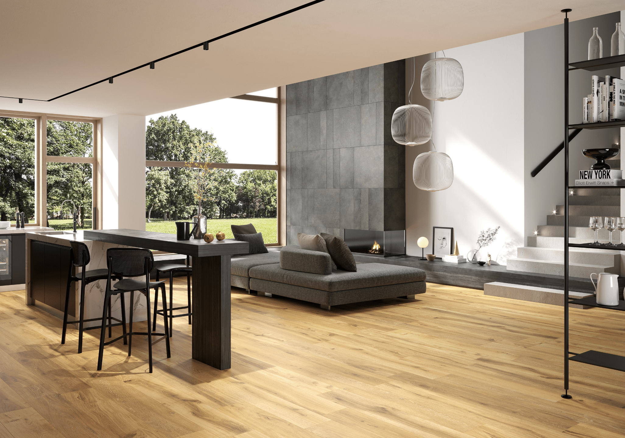 Fliesendorf zeigt ein offenes Wohnzimmer mit dunkler L-Couch, einem hohen Tisch mit Hockern und Fliesendielen im Holzlook am Boden.