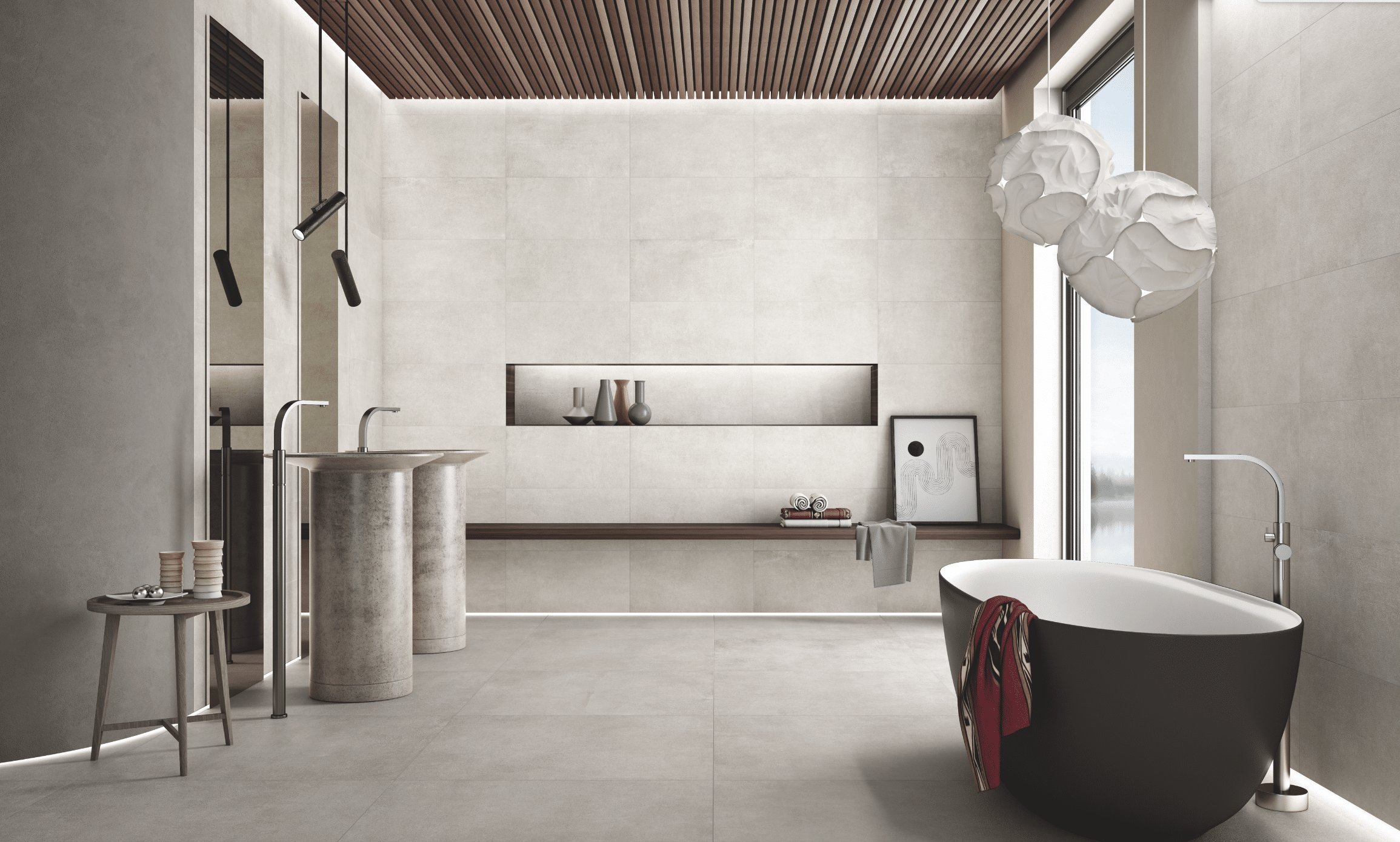 Fliesendorf zeigt ein Badezimmer mit hellem Fliesenboden und gefliester Wand mit einer dunklen, freistehenden Badewanne und Waschtisch mit silberner Armatur.