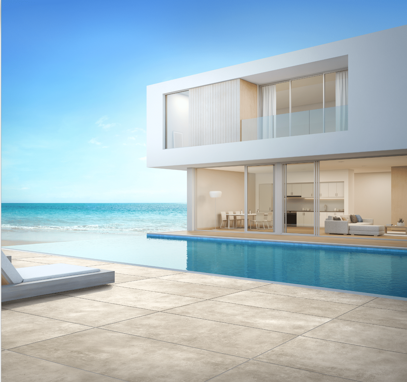 Fliesendorf zeigt ein modernes, weisses Haus am Meer mit einem Infinity Pool und gefliester Umrandung mit Sonnenliegen.
