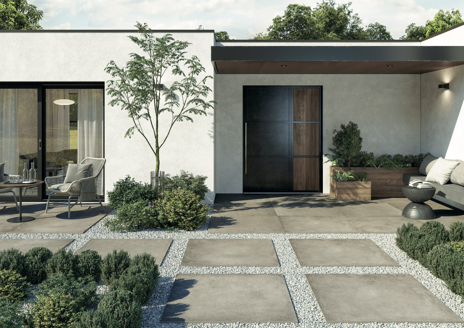 Fliesendorf zeigt den Eingangsbereich von einem modernen Haus mit Flachdach, gefliestem Boden und großen Steinplatten im Vorgarten mit Zugang zur Terrasse.