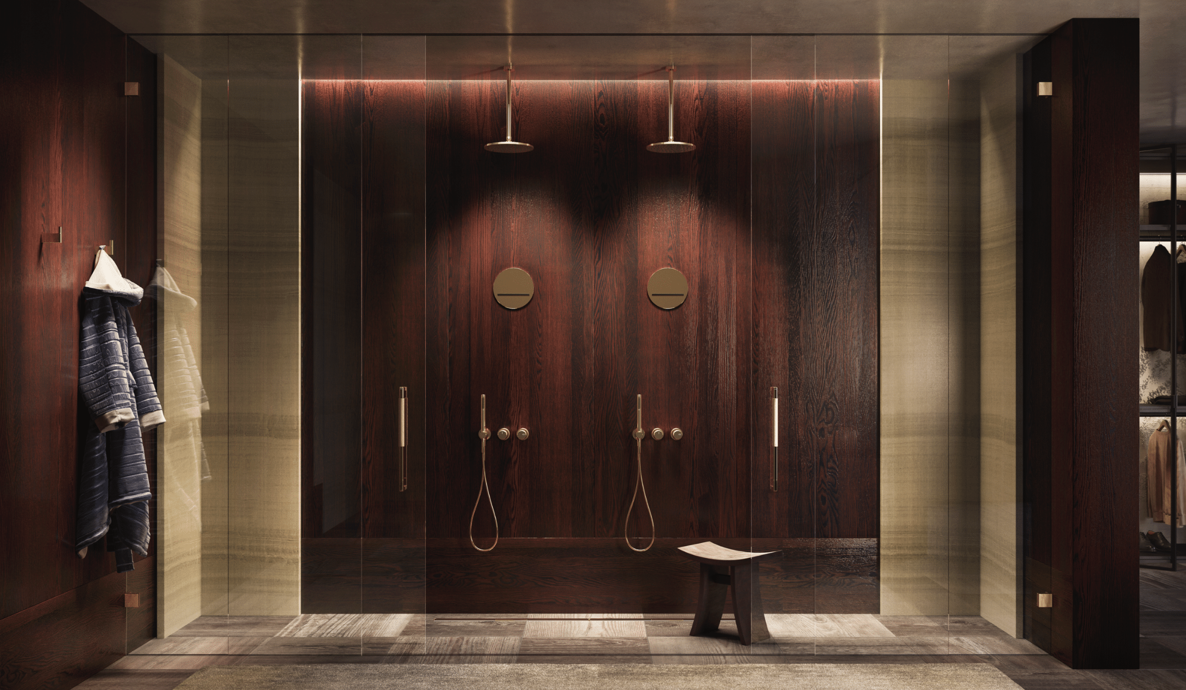 GESSI zeigt eine elegante Doppeldusche mit einer Rückwand aus dunklem Holz und goldenen Armaturen, gefliestem Boden und Kleiderhaken für Bademäntel.