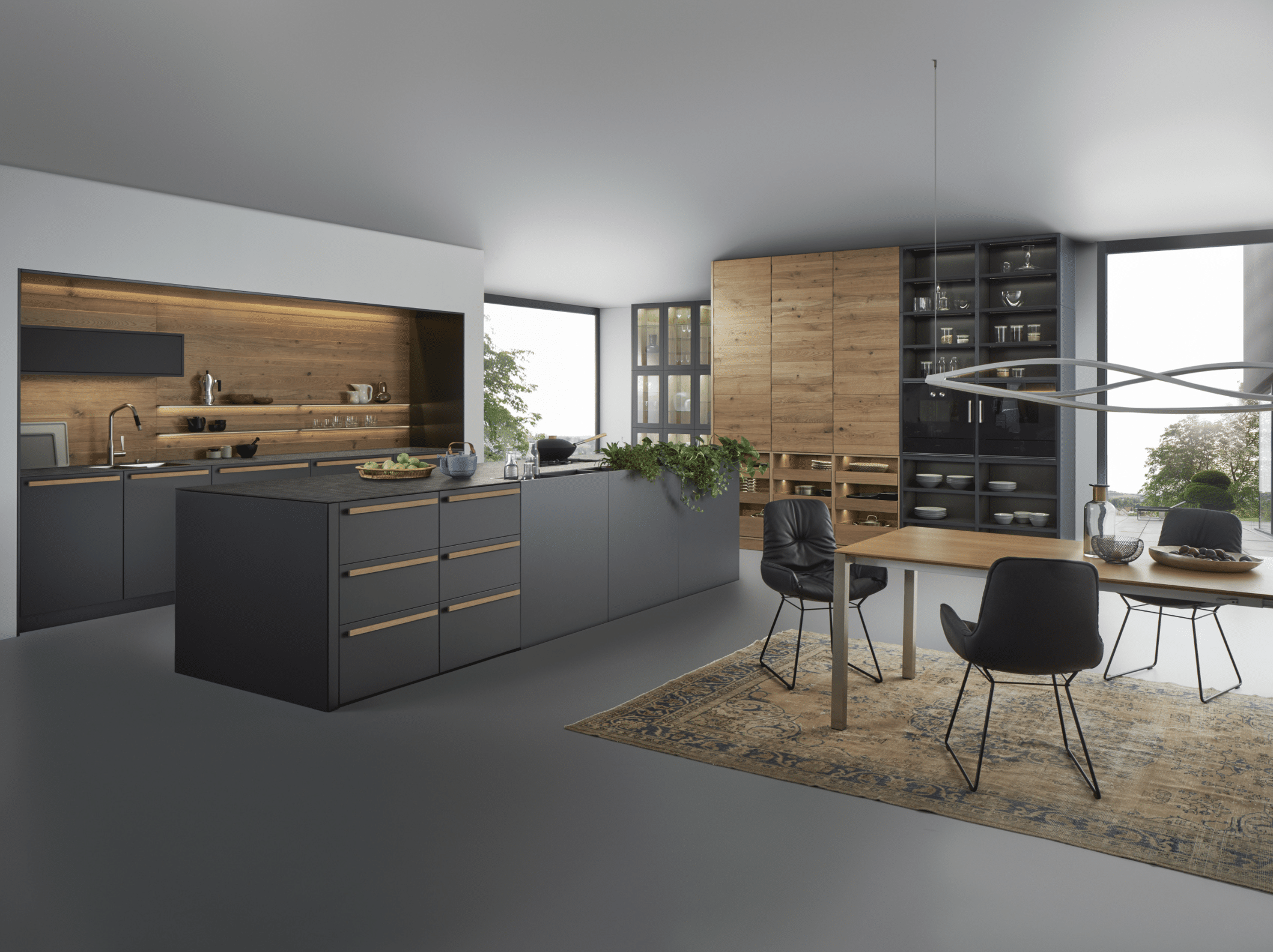 WOHNHAUS Grill & Ronacher zeigt eine moderne Inselküche von LEICHT Küchen mit dunklen, anthrazitfarbenen Holz-Fronten und hohen Schränken mit viel Stauraum.