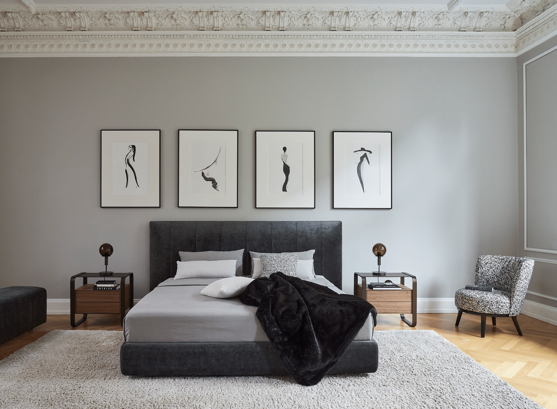 WOHNHAUS Grill & Ronacher zeigt ein Schlafzimmer in Grautönen und Stuck mit einem schwarzen Doppelbett und freiliegendem Teppich von Bielefelder Werkstätten.