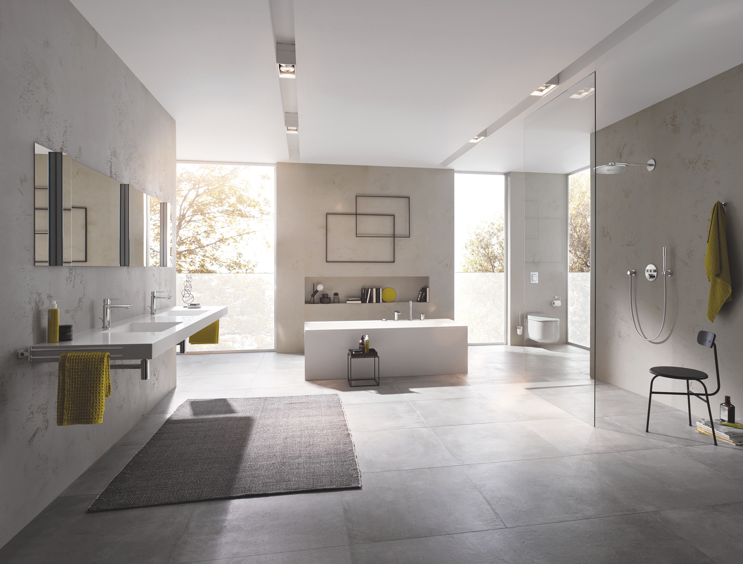 Grohe zeigt eine Badezimmer mit Rainshower Smart Active Dusche, dem Dusch-WC Sensia Arena mit Betätigungsplatte Skate Cosmopolitan und Doppel-Waschtisch mit Lineare-Armaturen.