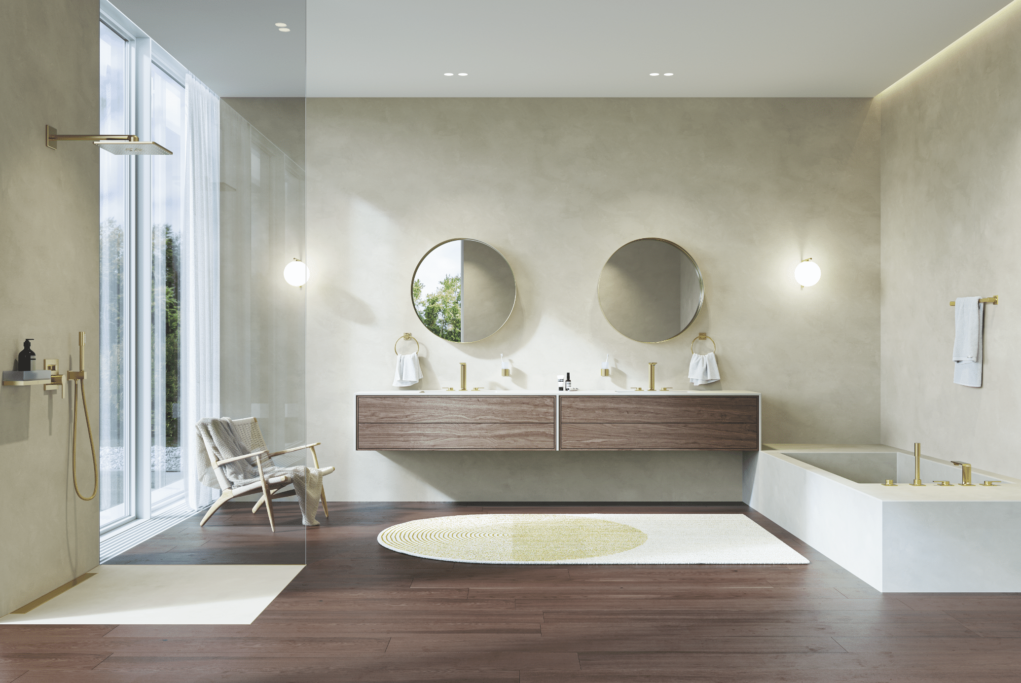 Grohe zeigt ein helles Badezimmer mit Doppelwaschtisch aus Holz mit runden Spiegeln, eine weisse Badewanne mit goldenen Armaturen und einer Dusche mit Glaswand.
