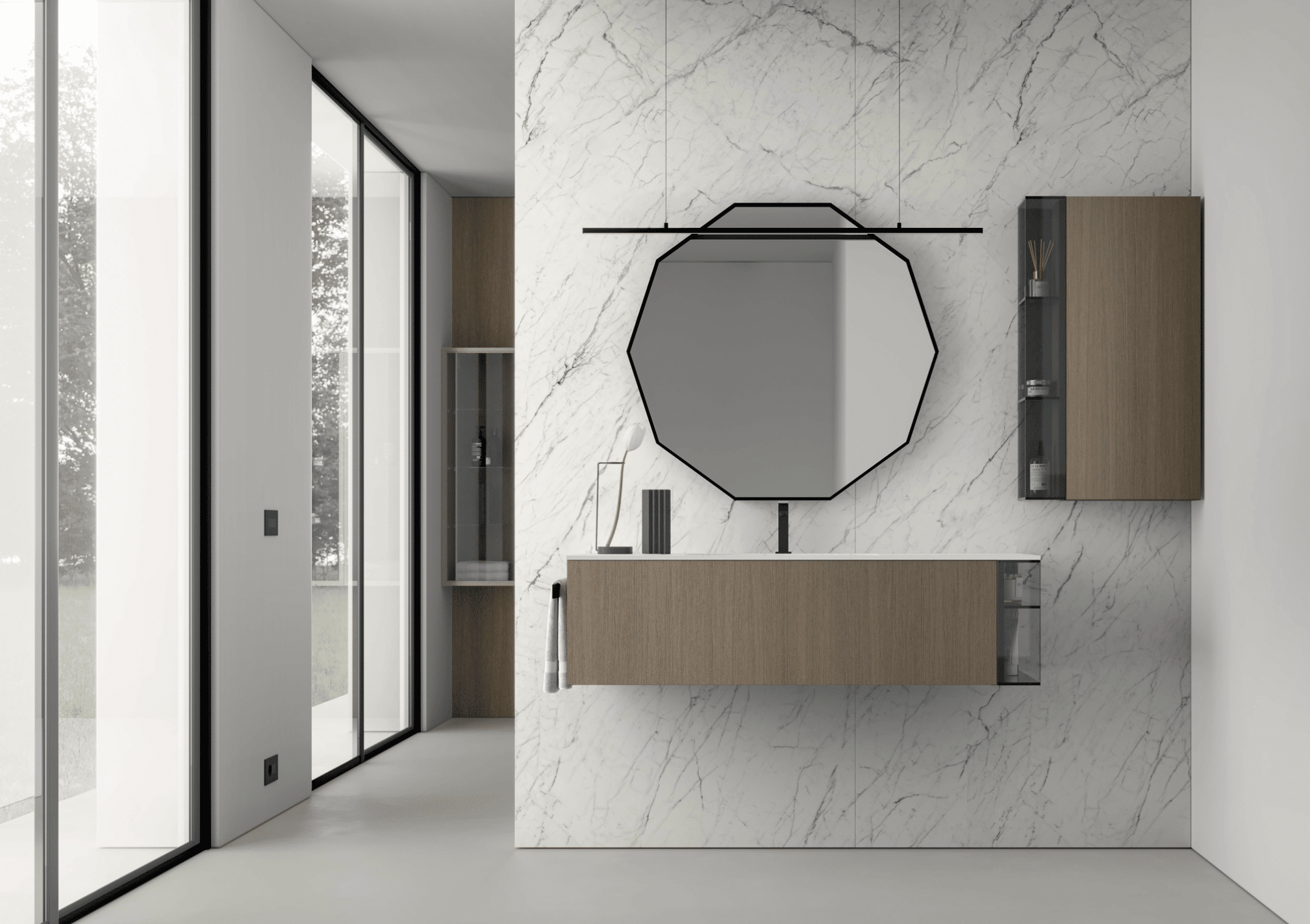 IDEA GROUP zeigt ein minimalistisch, modernes Badezimmer mit Waschtisch an der Wand mit weißen Marmorfliesen, zehn-eckigem Spiegel und Hängeschrank.
