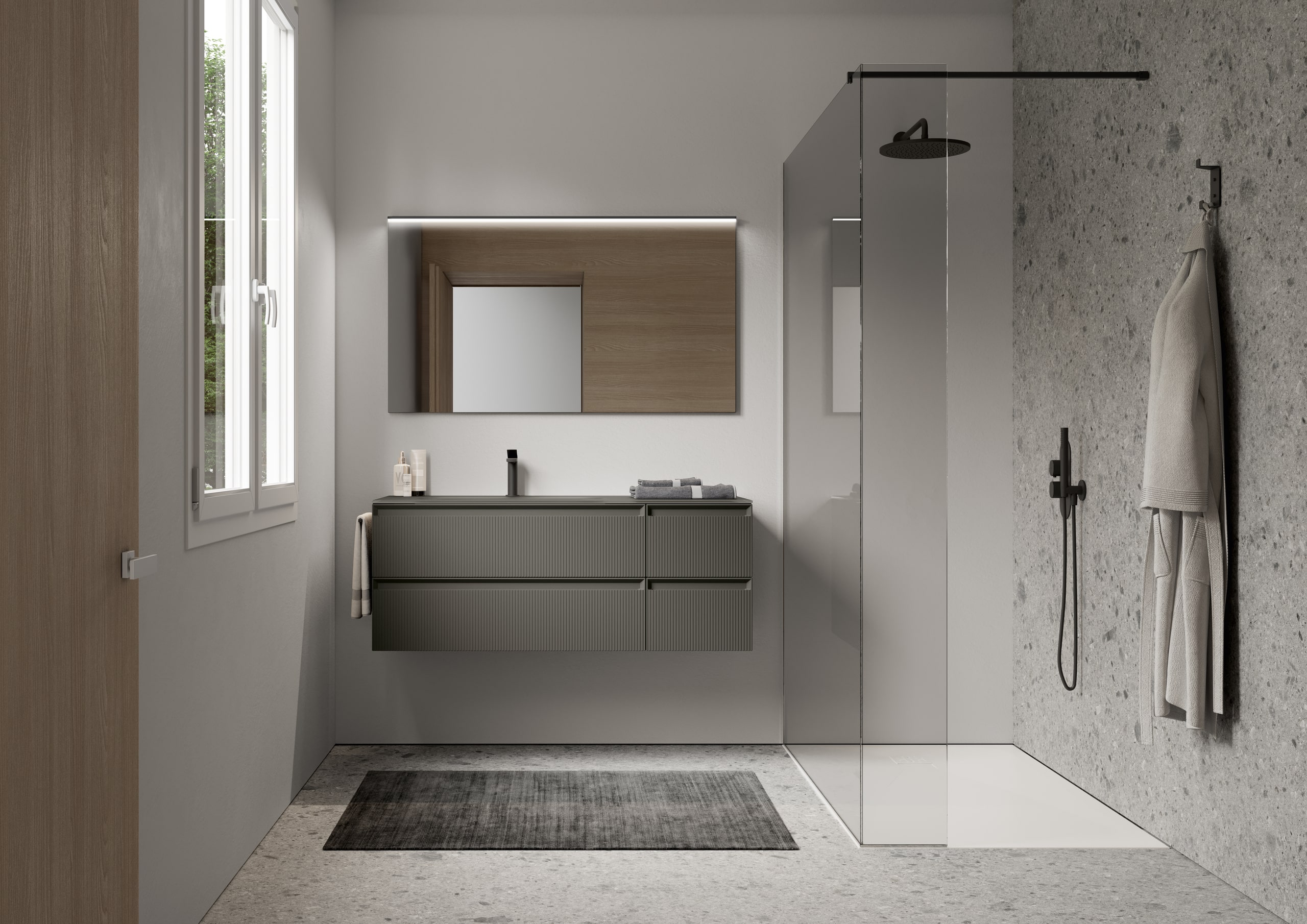 Badezimmer mit Walk-In Dusche und Waschtisch mit beleuchtetem Spiegel von Idea Group.