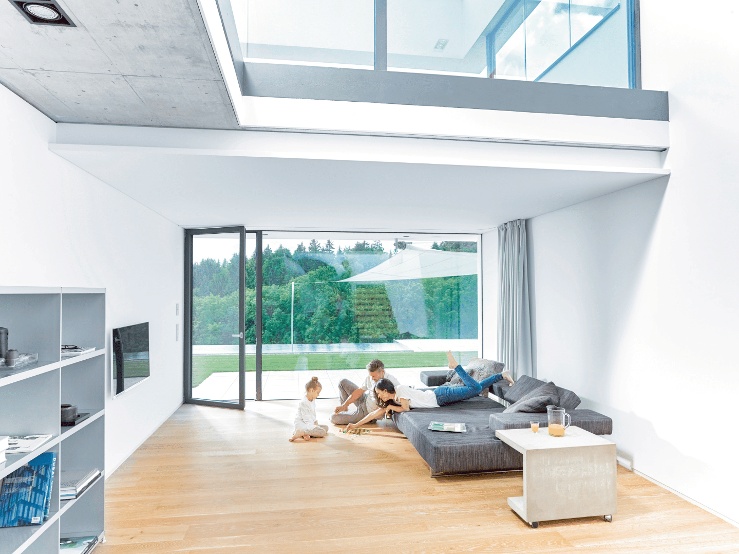 Internorm zeigt ein großzügiges, modernes Wohnzimmer mit Glaswänden und einer Terrassentür.