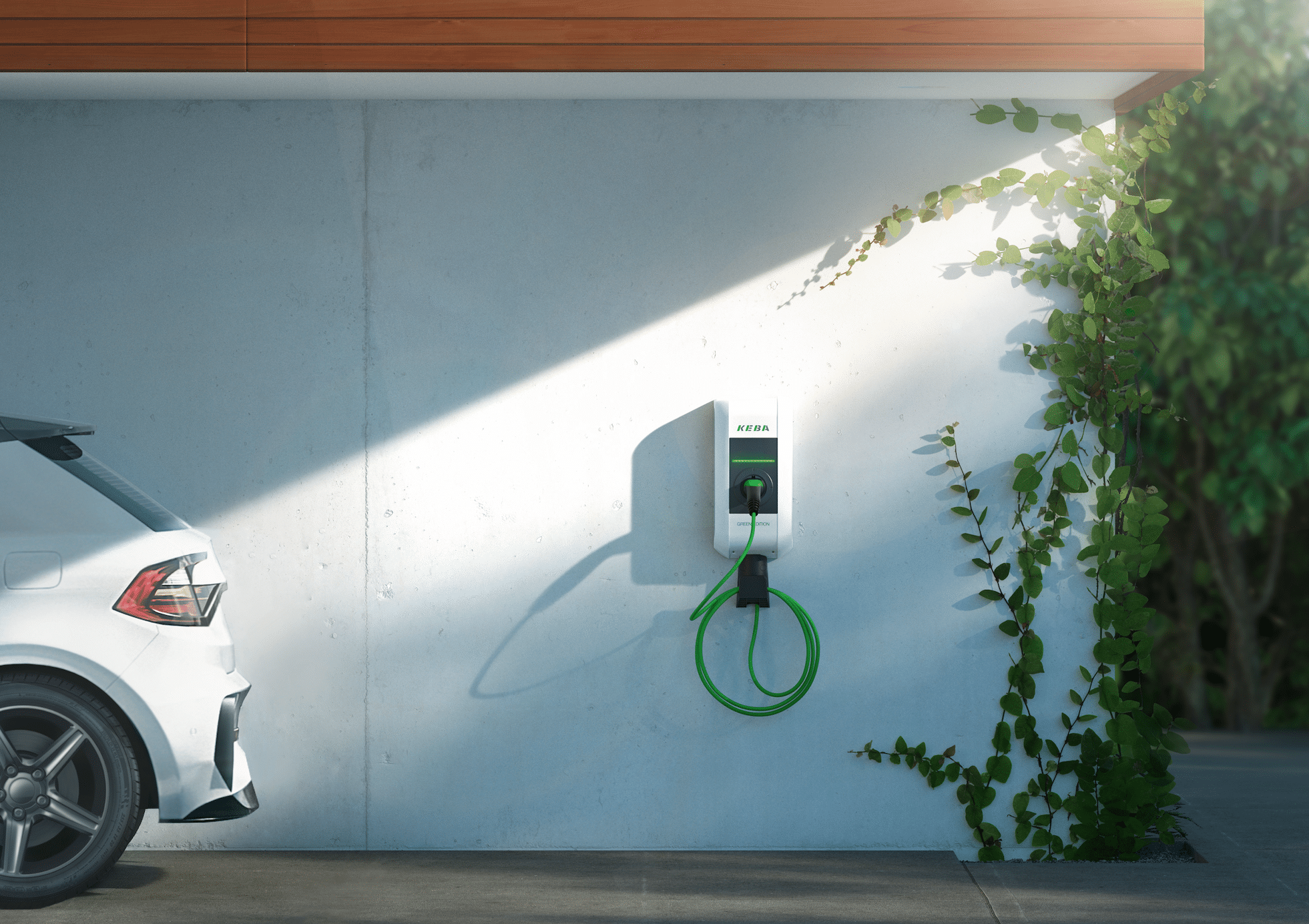 KEBA zeigt eine Ladestation für E-Autos an der Wand einer weissen Garage mit Pflanzen.
