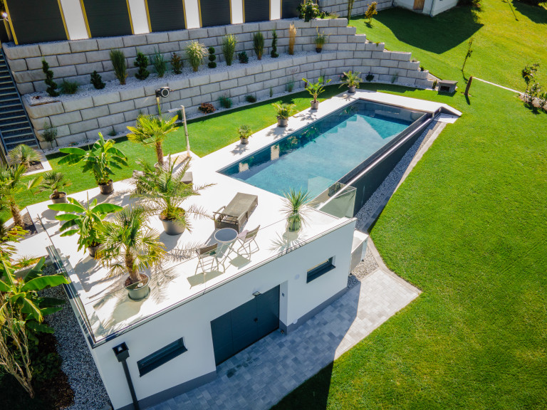 Garage mit Dachterrasse, Liegestuhl, Grünpflanzen und Pool von B. Kern Baugesellschaft.