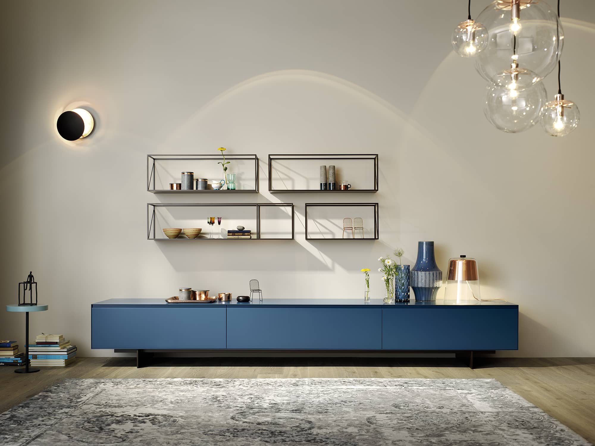 Wohnzimmer im Industrial Style mit akzentgebendem Lowboard in blau und minimalistischen Hängeregalen von haas.