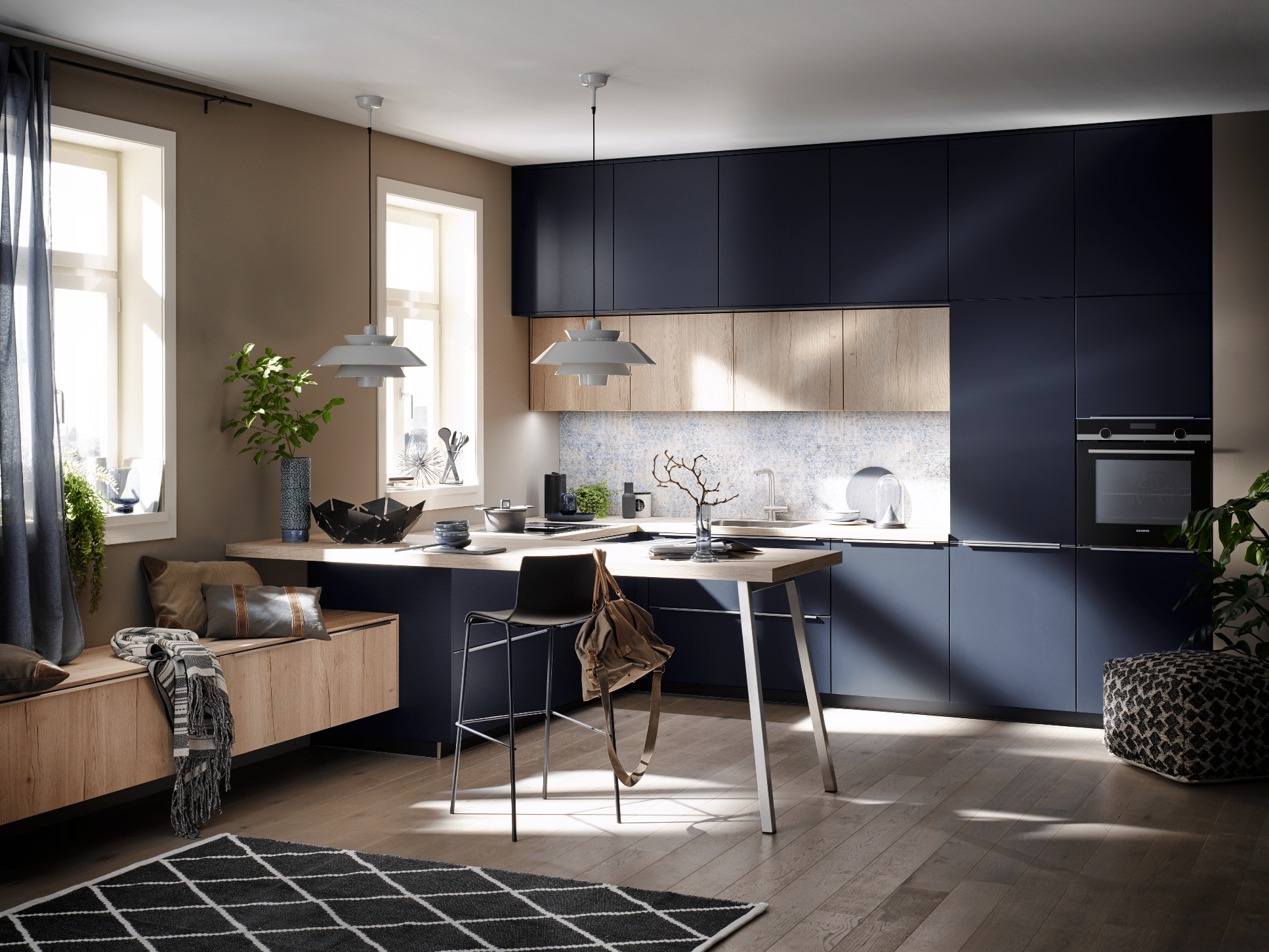 Tischlerei Bauer präsentiert eine dunkelblaue Häcker Küche mit hellen Holztönen, einem Tisch mit Barfunktion und einem hohen Stuhl.